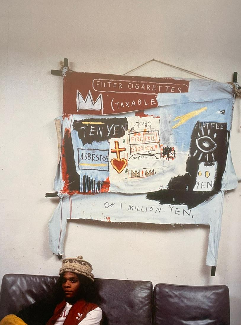Jean Michel Basquiat - Basquiat in Front of One Million Yen, 1982: JEAN MICHEL BASQUIAT (1960-1988) Basquiat in front of One Million Yen, 1982 at his exhibition at Fun Gallery Print in Colors 8 3/4" x 12" Jean-Michel Basquiat was an influential African-American artis