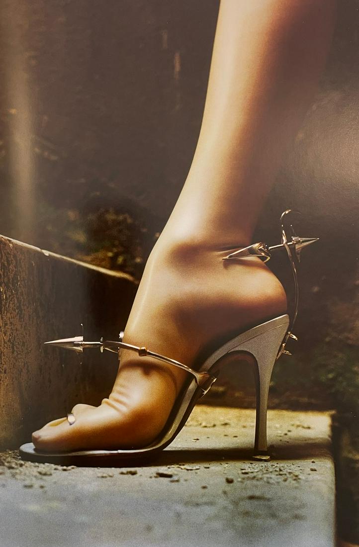 Helmut Newton - Shoe by Tristan Webber, 1999: HELMUT NEWTON (1920-2004) Show by Tristan Webber, Italian Vogue, Miami, Florida, 1999 Print in Colors 9 1/4" x 13 3/4" Helmut Newton was a German high-fashion photographer whose subversive approach to
