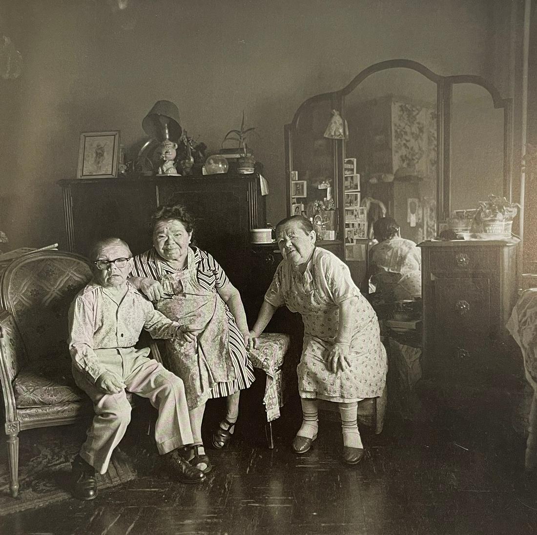 Diane Arbus - Russian Midget Friends in a Living Room, 1963: DIANE ARBUS (1923-1971) Russian Midget Friends in a Living Room on 100th street, NYC, 1963 Print in Colors, Printed in the 1970s 8 1/4" x 8 1/4" Diane Arbus was an American photographer best known for