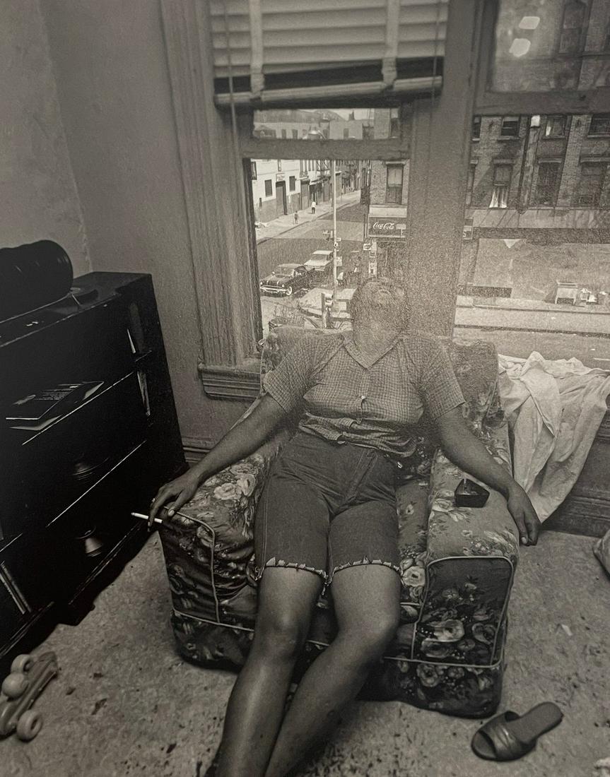 Bruce Davidson - East 100th Street, 1967: BRUCE DAVIDSON (B. 1933) East 100th Street, 1967 Print in Colors 7 1/2" x 9 1/4" Bruce Davidson is an American photographer known for capturing images of communities and individuals living on the frin