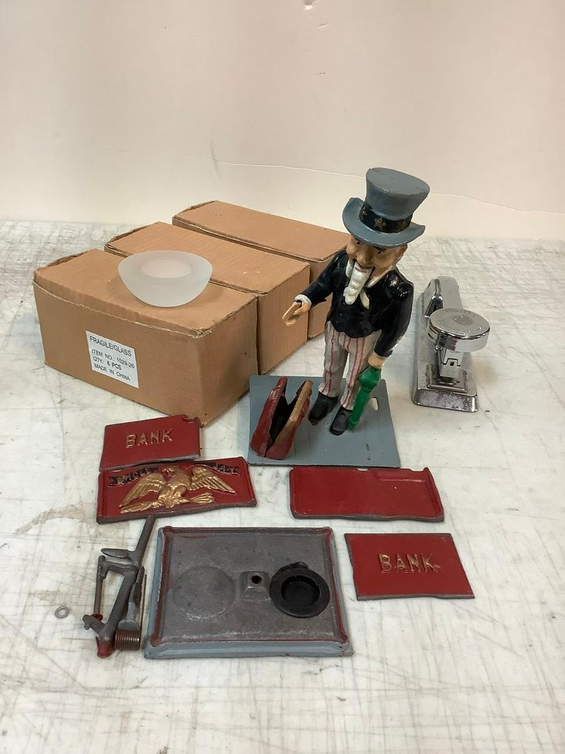 Lot of Cast Iron Uncle Sam Bank (needs repairing), 3 boxes of tea light candle holders and stapler (1 of 1)