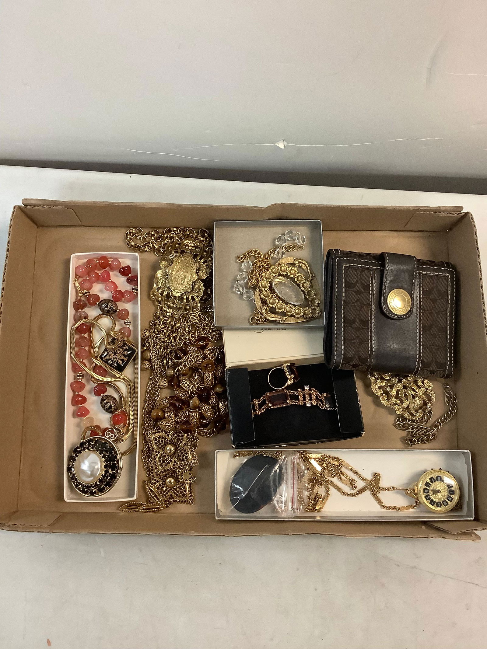 Lot of gold toned jewelry and coach wallet: Lot of gold toned jewelry and coach wallet