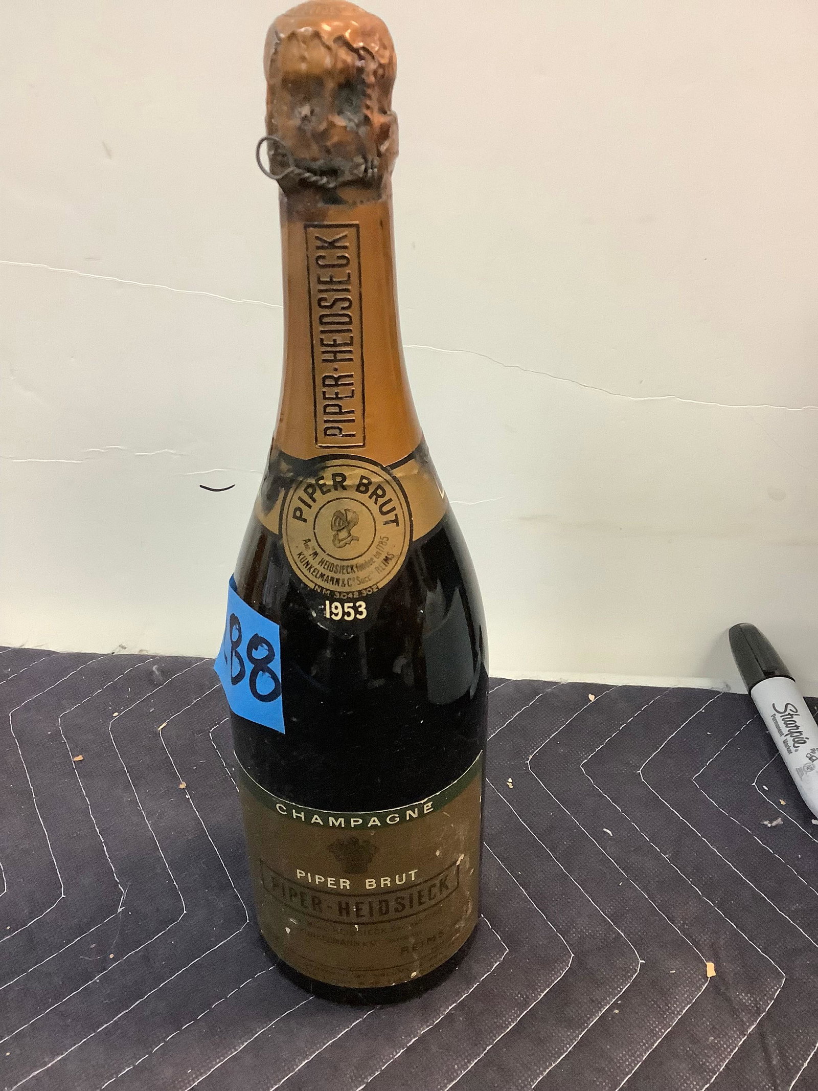 1953 Piper Brut Champagne - Sealed: Any contents in bottle is Free; You are bidding on the bottle & unbroken tax stamp