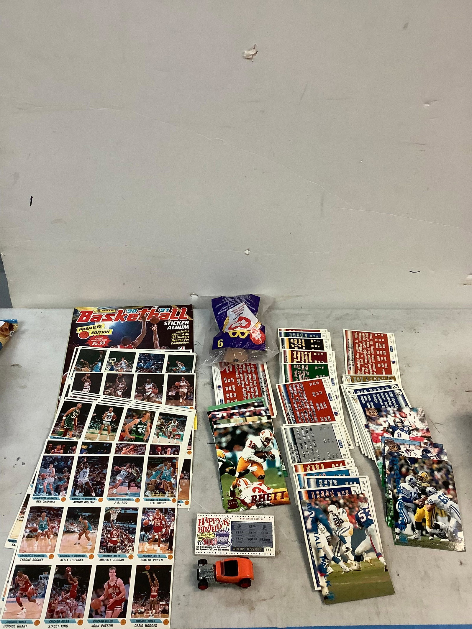 lot of basket ball cards, magazines, football cards, lottery tickets, McDonalds plush, and toy car: lot of basket ball cards, magazines, football cards, lottery tickets, McDonalds plush, and toy car
