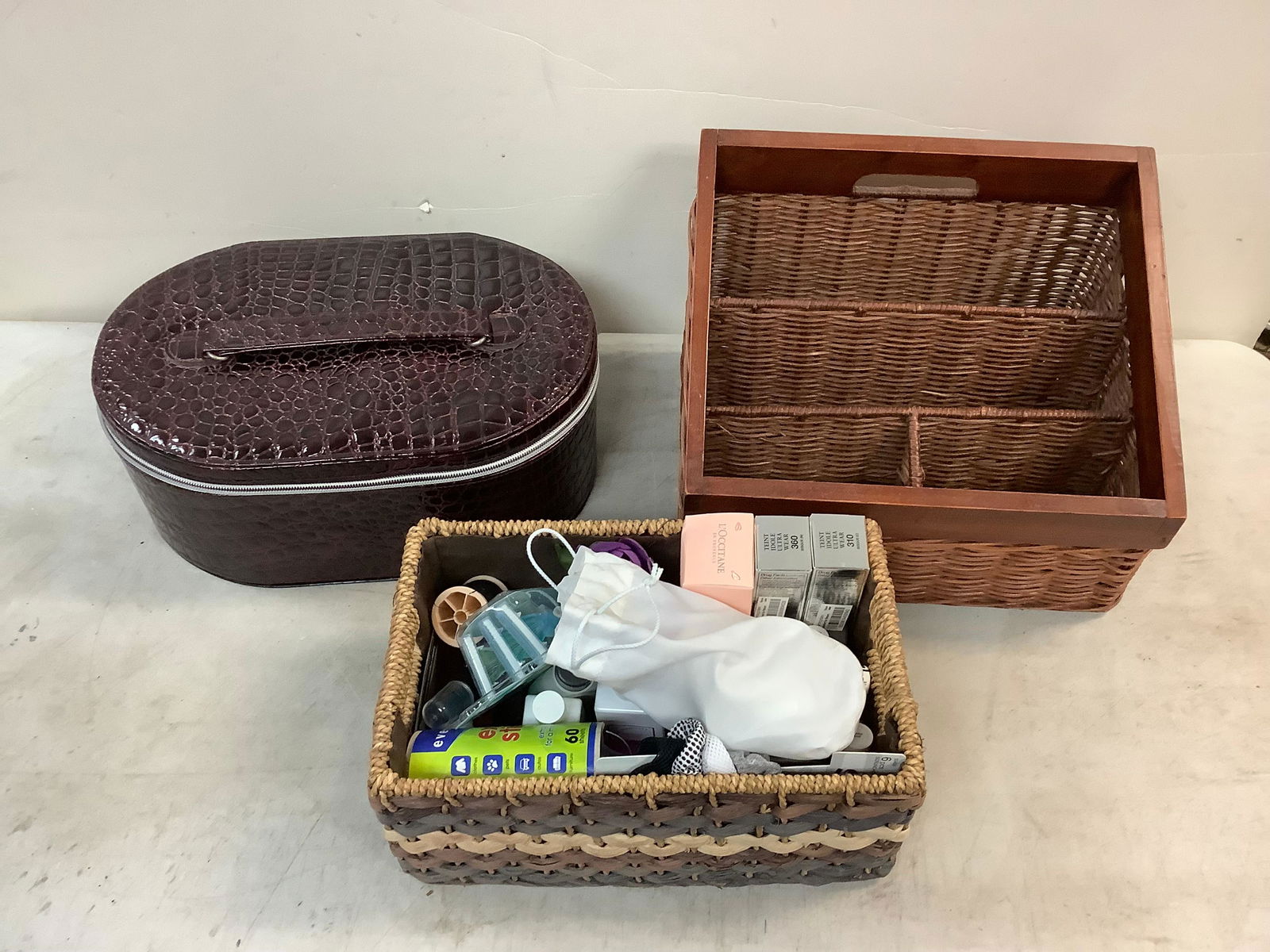 Lot of wicker slotted storage bin, various cosmetics, and purple faux snakeskin sewing kit with (1 of 1)