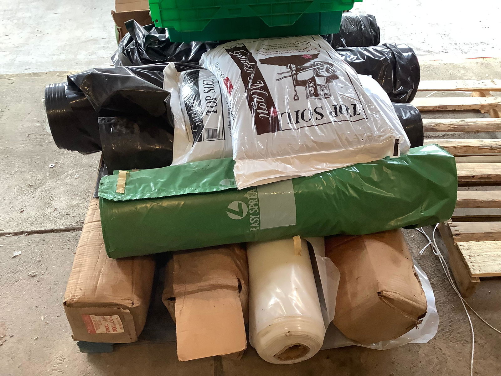 Pallet full of plastic wrap and top soil (1 of 1)