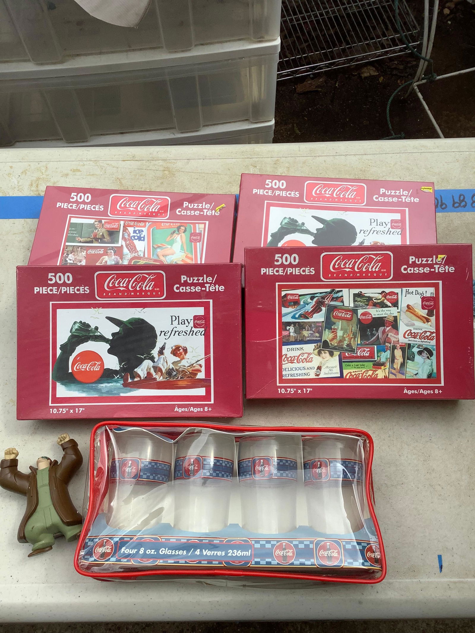 Lot of coca cola puzzles, 8oz. glasses, and action figure (1 of 1)
