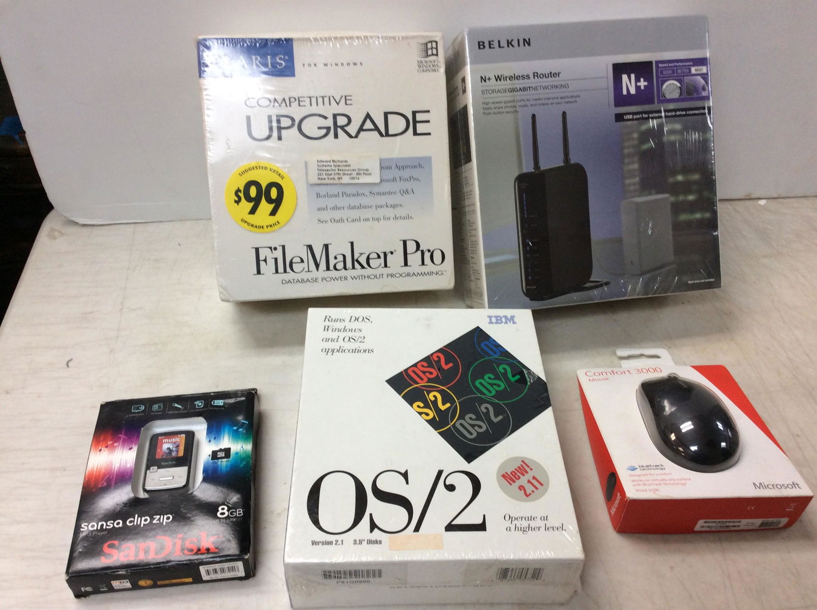 Lot of various computer supplies including sandisk MP3 Player 8gb, Belkin wireless router, comfort (1 of 1)