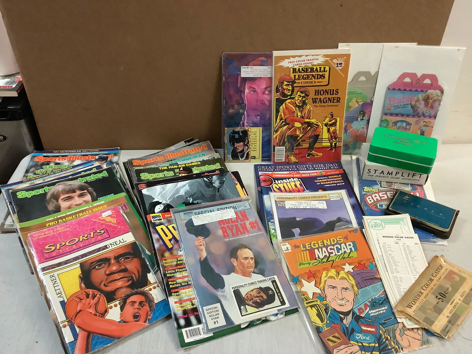 Lot of ink stamp pads, fake dollar notes, various magazines and comics and 1992 MCDonalds happy meal (1 of 1)