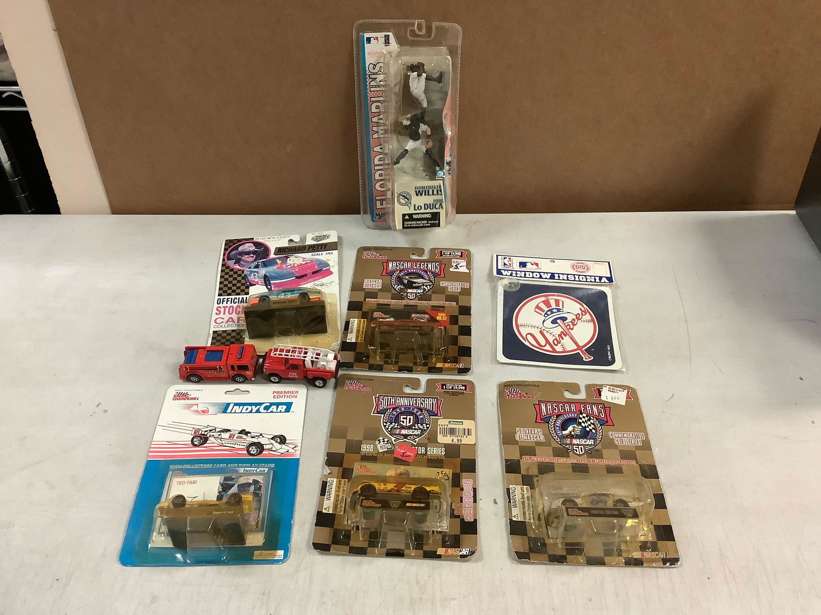 Lot of RACING CHAMPIONS, ROAD CHAMPS, HOTWHEELS, MAISTO toy cars, MARLINS baseball action figure and (1 of 1)