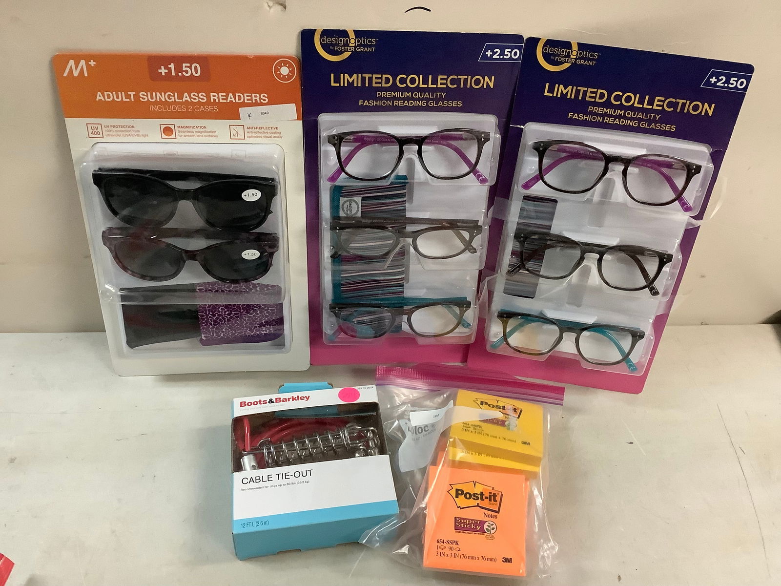 Lot of designoptics reading glasses, post-it notes, and dog cable (1 of 1)