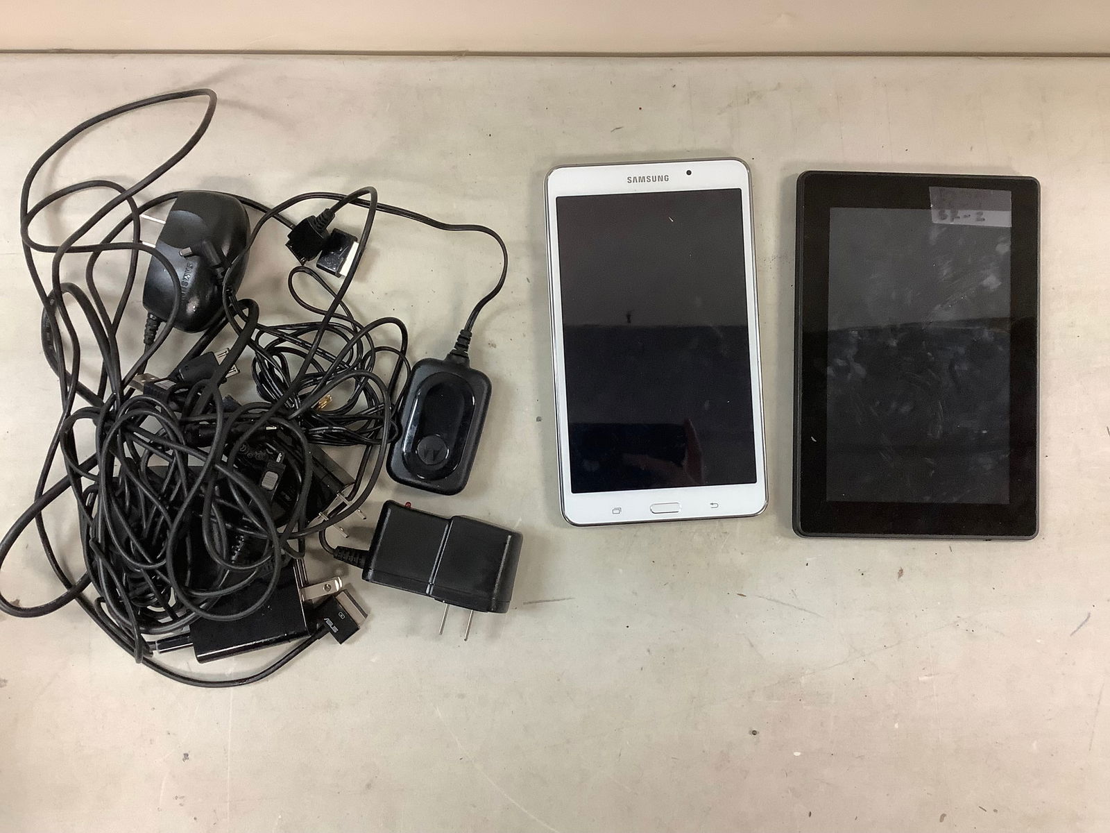 Lot of amazon kindle, samsung tablet, and various wires (1 of 1)
