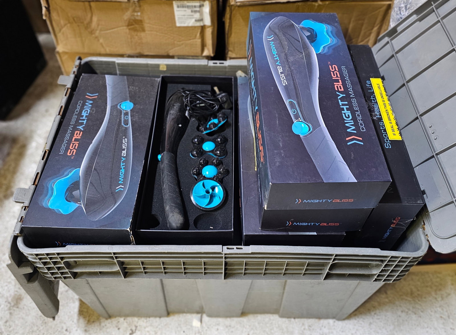 Crate of Mighty Bliss Cordless Massagers: note seals are broken