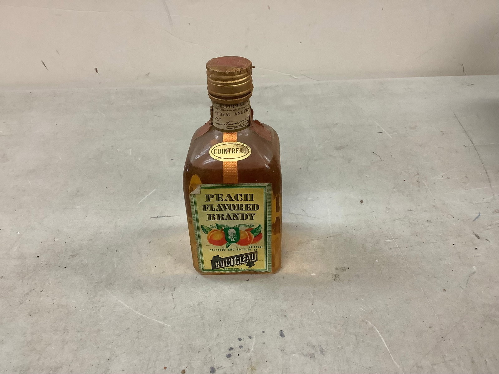 Cointreau Peach Flavored Brandy: Any contents in bottle is Free; You are bidding on the bottle & unbroken tax stamp
