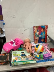 Lot of childrens toys, toy car,fake baby, playing games, and more