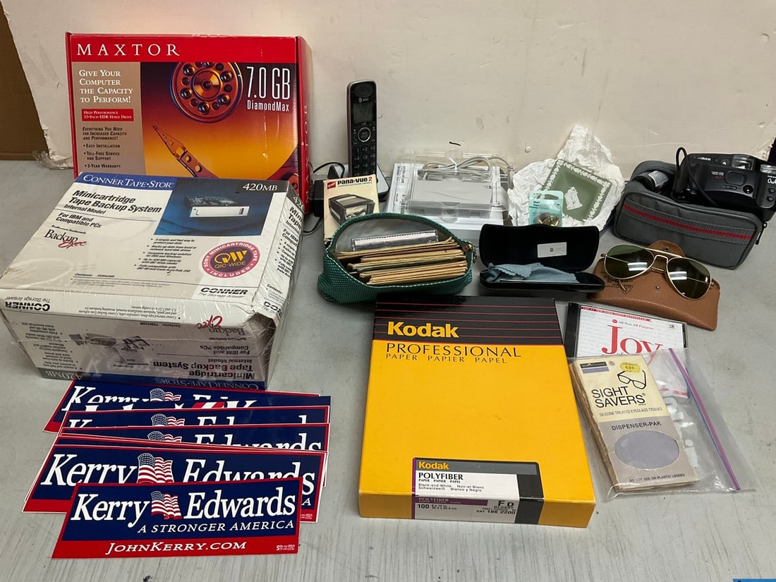 Sunglasses, Kodak paper, Canon sureshot owl camera with case, political bumper stickers, and more (1 of 1)