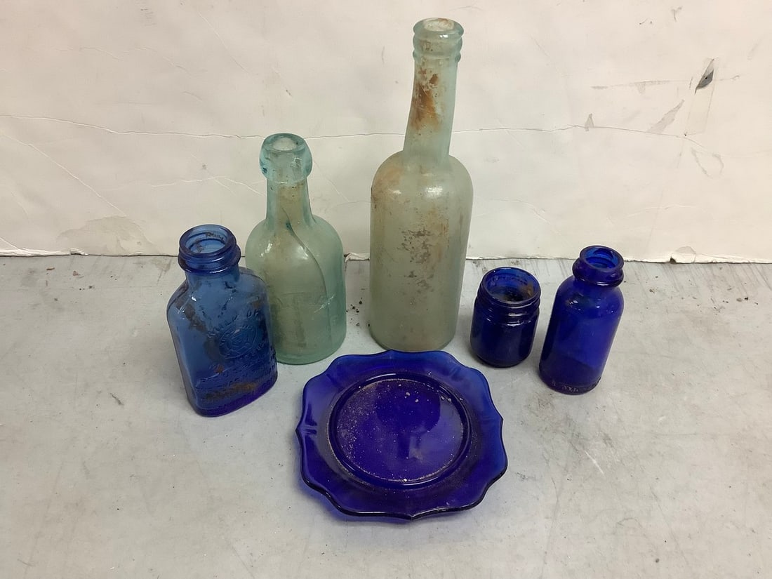 Blue glass and clear glss vintage bottles and small plate 9in tallest: Blue glass and clear glss vintage bottles and small plate 9in tallest