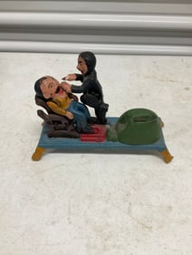 vintage dentist pulling a tooth cast bank
