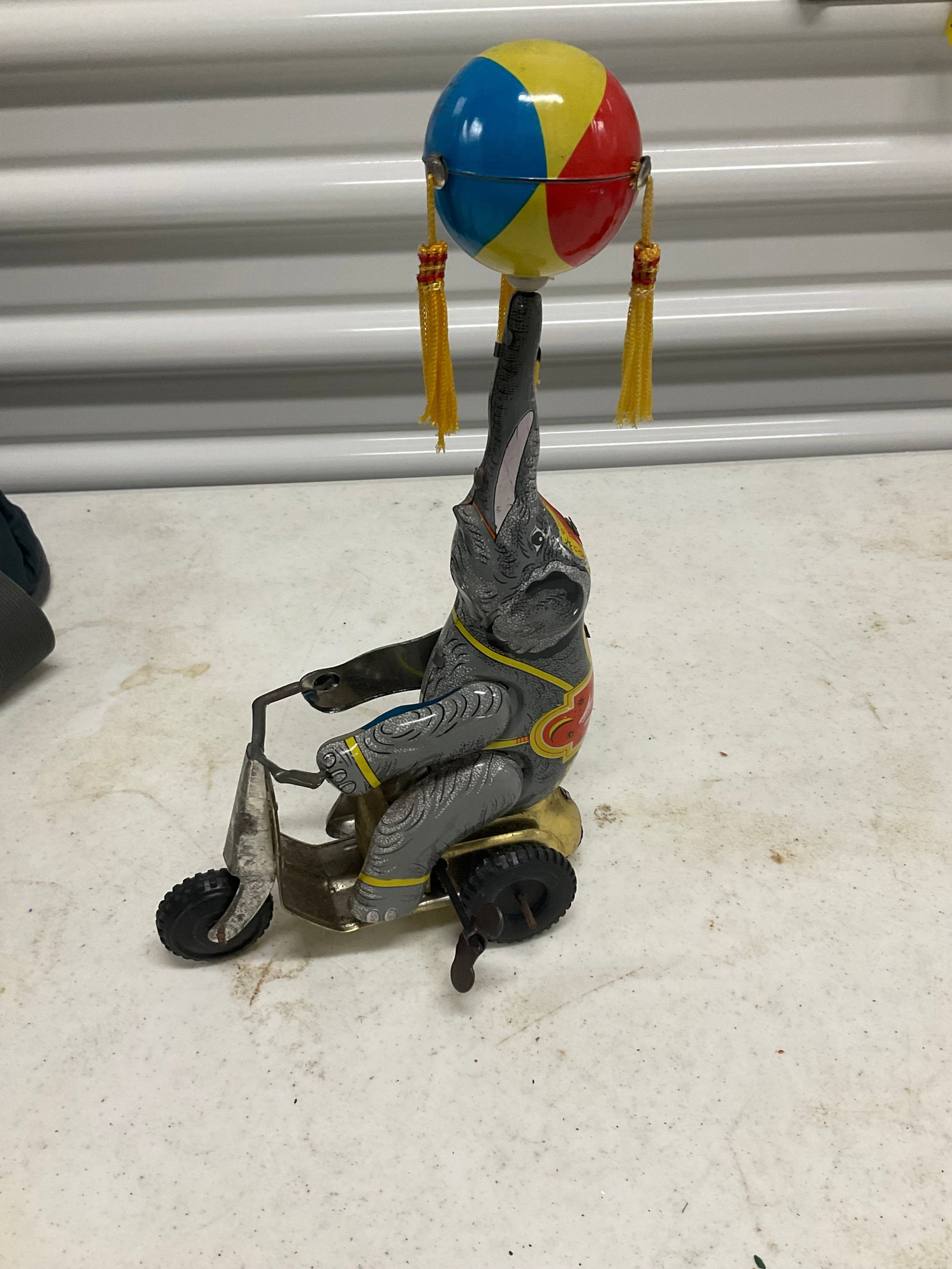 vintage tin cycling elephant on bike toy: vintage tin cycling elephant on bike toy