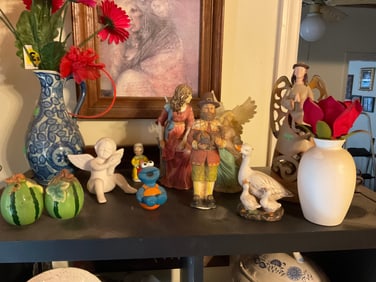 shelf full of various firgines; vase and more