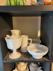 shelf full of milk glass