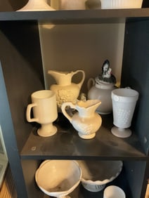 shelf full of milk glass