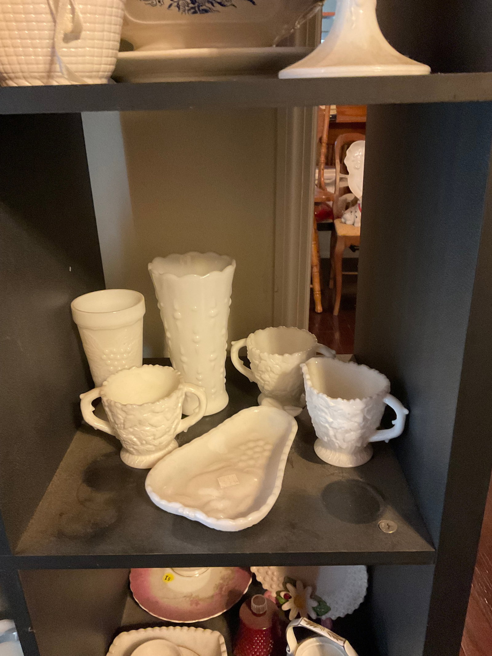 shelf full of milk glass: tallest is 8" tall