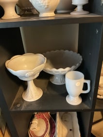 shelf full of milk glass