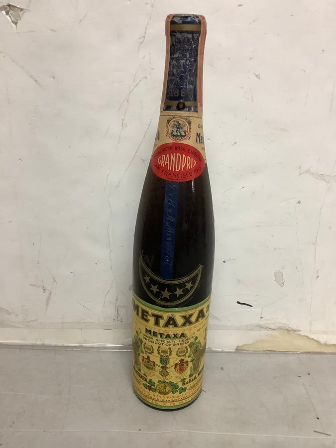 1915 Metaxa greek specialty liqueur (92 proof 4/5 quart, seled): Any contents in bottle is Free; You are bidding on the bottle & unbroken tax stamp