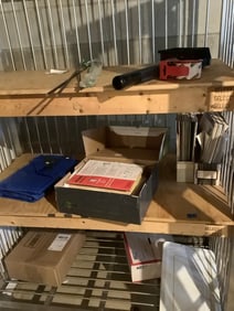 Contents of shelving unit(tarp, manuals, and more)