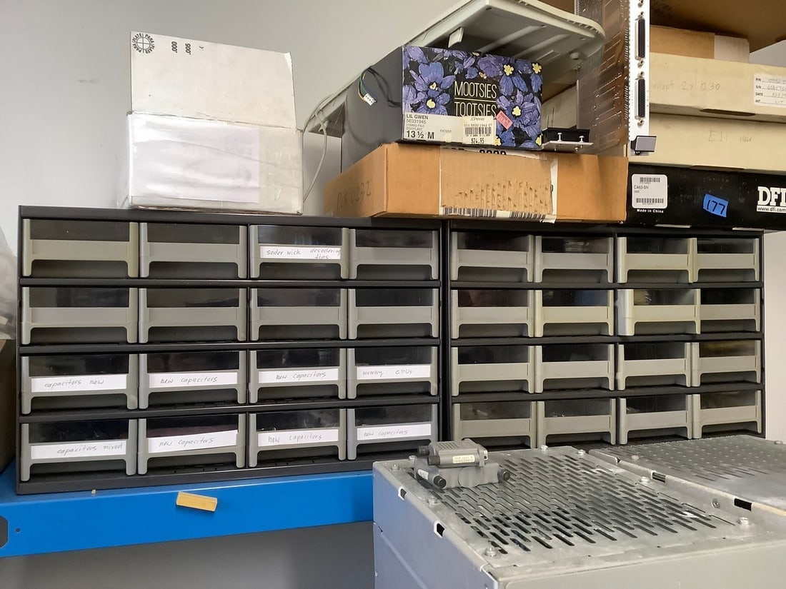 Parts bins with capacitors, soder wick, and more: Parts bins with capacitors, soder wick, and more
