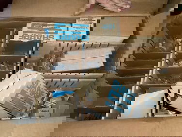 Box full of paint spray gun rebuild kits