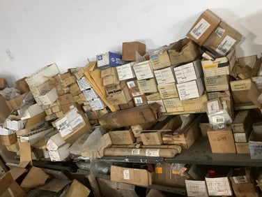 Large pile of anchor bolts, rebuild kits, and more(everything on and under racking system)