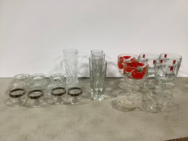 Various drinking glasses, glass pitcher(7.25in.tall), and candleholders