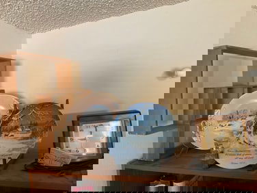 shelf full of mcm cubby plates, clocks and more