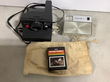 Westinghouse alarm clock, Polaroid camera, and Atari Demon Attack game