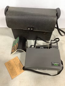 Vintage Polaroid 430 camera with focused flash attachment and carrying case