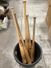 Wooden Louisville Slugger bats and outdoor planter