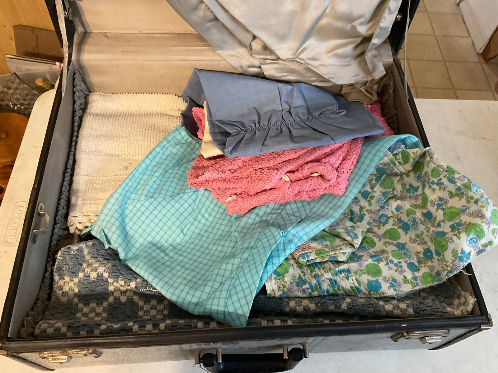 Vintage suitcase full of linens and more: Vintage suitcase full of linens and more