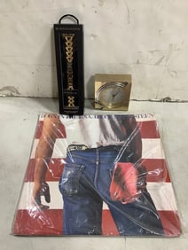 Seiko clock, apple watch chain accessory, and Bruce Springsteen record