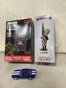 Star Wars Chewbacca Berries Funk tshirt, Donald Trump bobblehead, and 1987 Camaro model