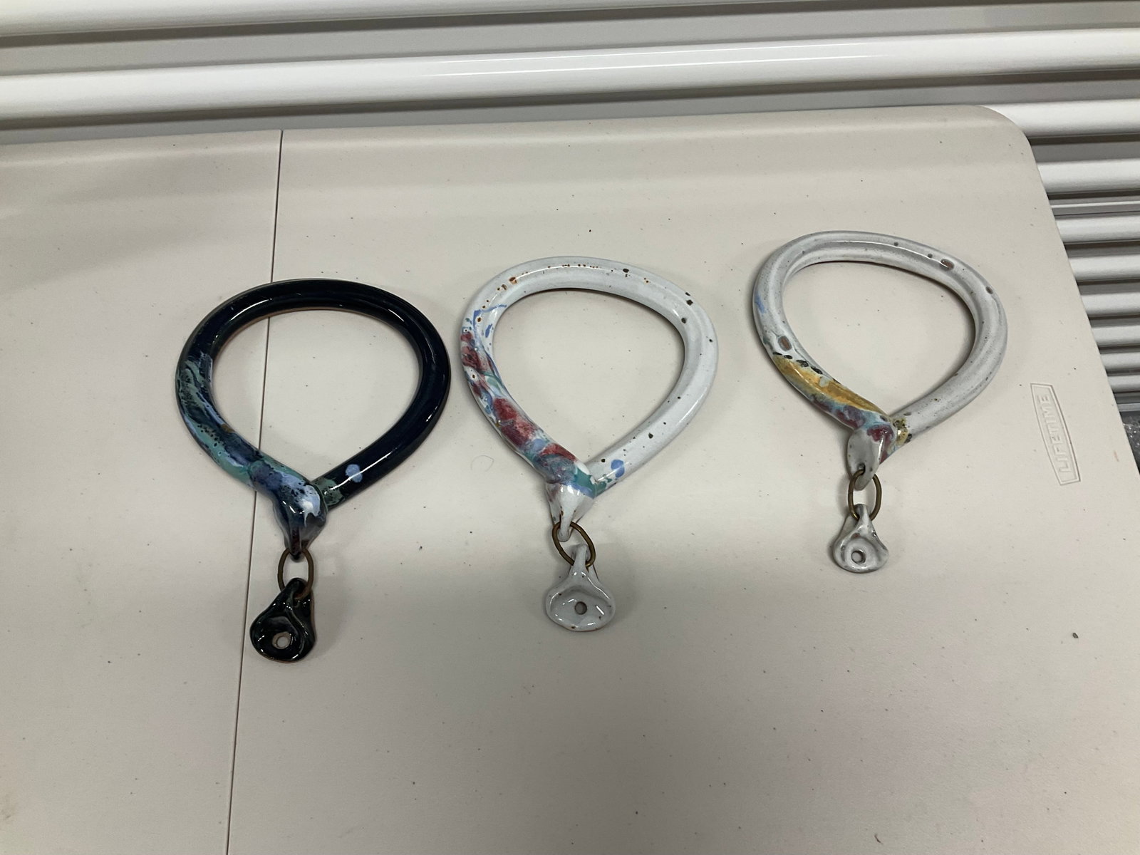 lot of hand painted ceramic towel holders: lot of hand painted ceramic towel holders
