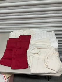 lot full of bed linens
