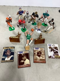 Various collectible sports figures with cards
