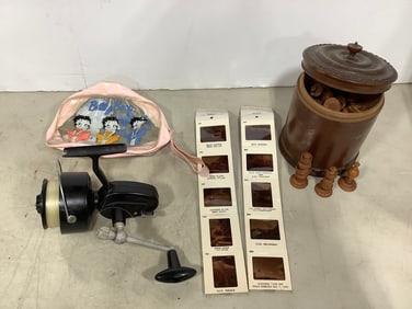 Betty Boop fanny pack, fishing reel, U.S. Navy photographs, and wooden chess set