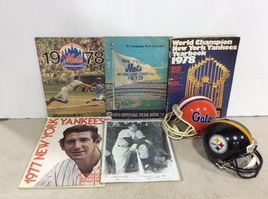 Miniature football collectible helmets and sports yearbooks