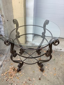 Wrought iron and glass top patio table(30inacross.x30in.high)