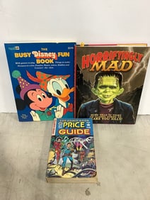Horrifyingly Mad book, The Busy Disney fun book, and The Comic Book price guide