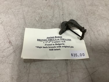 Ancient Roman bronze fibula or toga pin