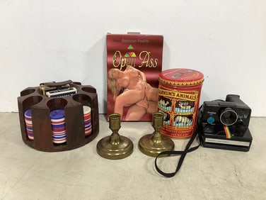 Polaroid instant camera, poker set, brass candleholders, Barnum's Animal cracker biscuit